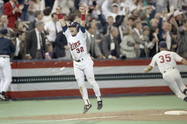 The Minnesota Twins' Dan Gladden celebrates as he heads home on teammate's Gen Larkin's single ...