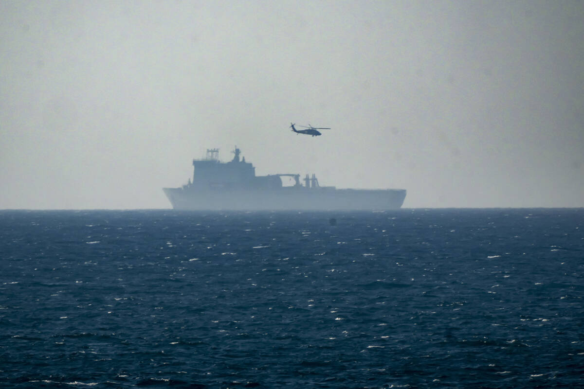 A ship is seen off the coast of Gaza near a U.S.-built floating pier, not seen, that is used to ...