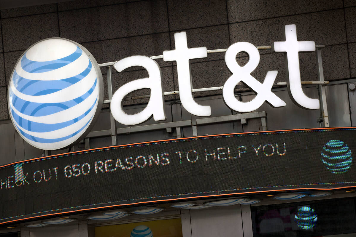 The AT&T logo is positioned above one of its retail stores in New York, Oct. 24, 2016. (AP Phot ...