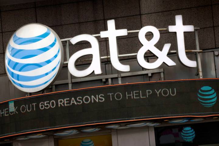 The AT&T logo is positioned above one of its retail stores in New York, Oct. 24, 2016. (AP Phot ...