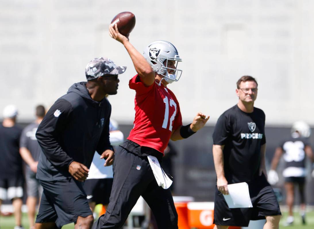 Raiders quarterback Aidan O'Connell (12) throws the ball during an NFL football practice at the ...