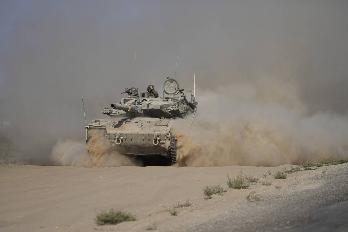 An Israeli tank maneuvers near the Israel-Gaza border in southern Israel, Friday, July 12, 2024 ...