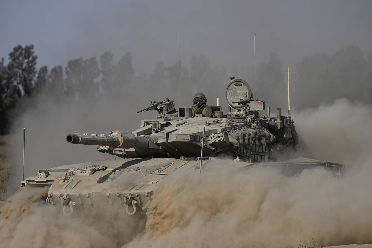 An Israeli tank maneuvers near the Israel-Gaza border in southern Israel, Friday, July 12, 2024 ...