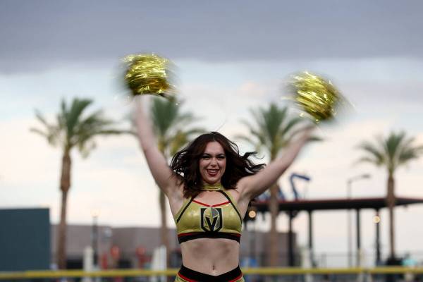 A Vegas Viva cheerleader dances under stormy skies during the annual Battle for Vegas charity s ...