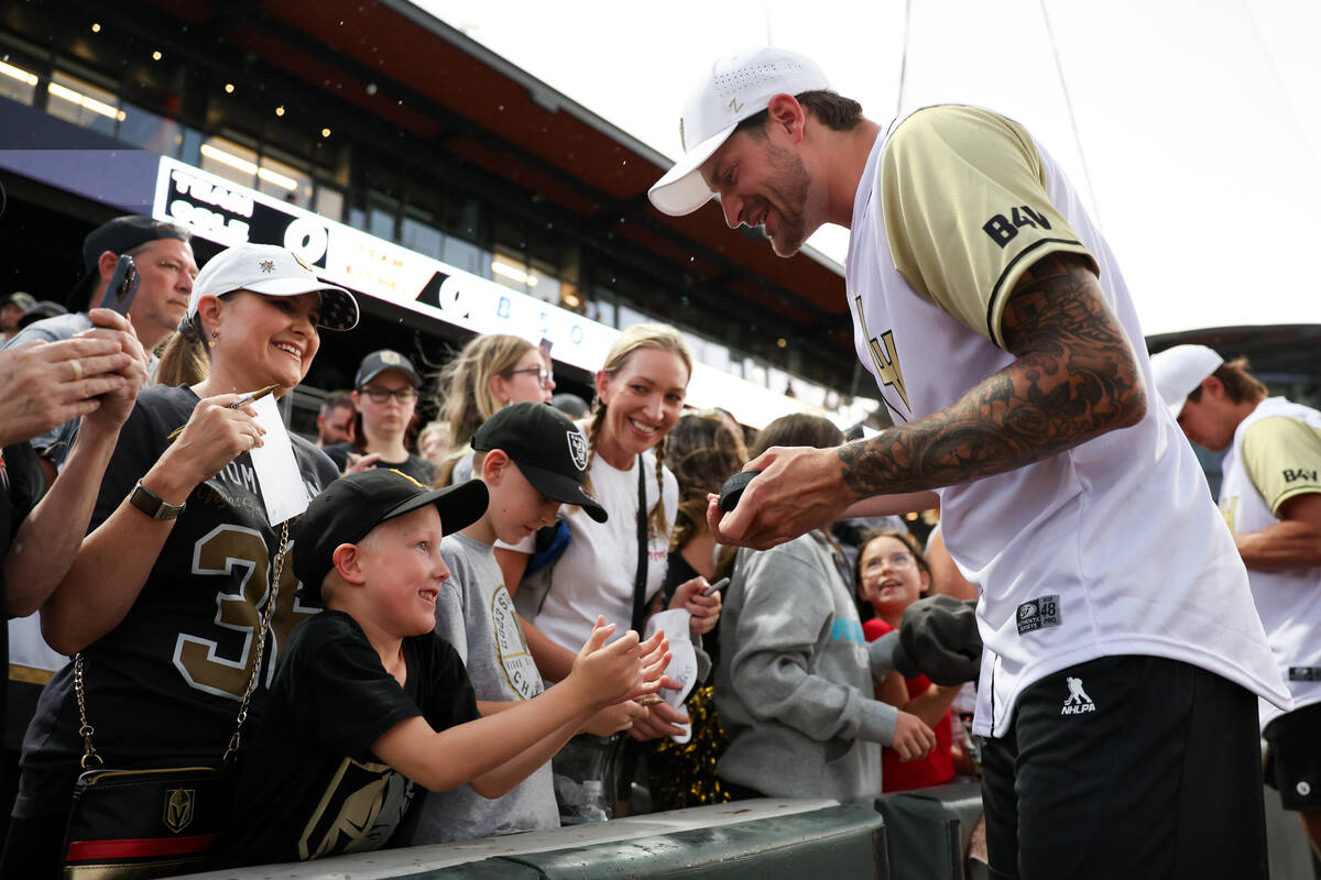 Golden Knights goaltender Adin Hill signs autographs for fans during the annual Battle for Vega ...