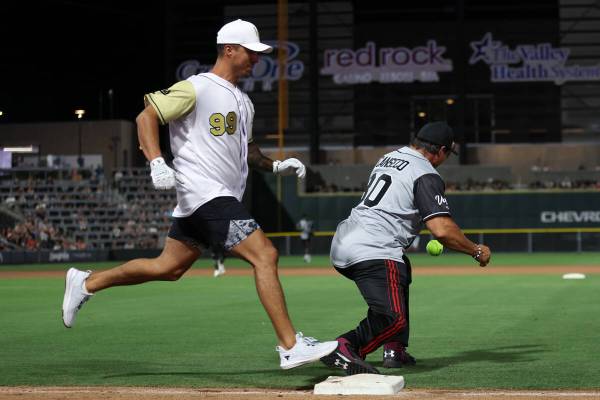Golden Knights manual therapist Raul Dorantes makes it safely to first base while the Raiders&# ...