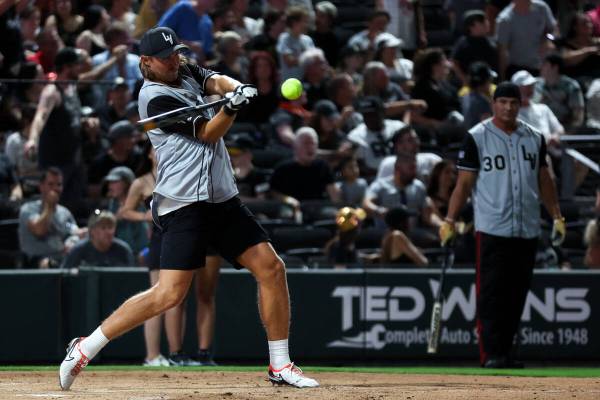 Raiders punter A.J. Cole bats against the Golden Knights during the annual Battle for Vegas cha ...