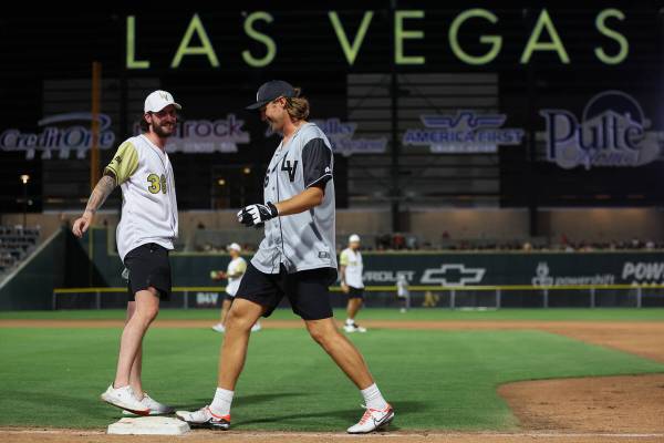Former Golden Knights goaltender Logan Thompson, left, and Raiders punter A.J. Cole goof off at ...