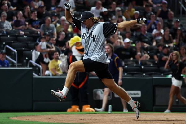 Raiders punter A.J. Cole makes a show of reaching home plate to score during the annual Battle ...