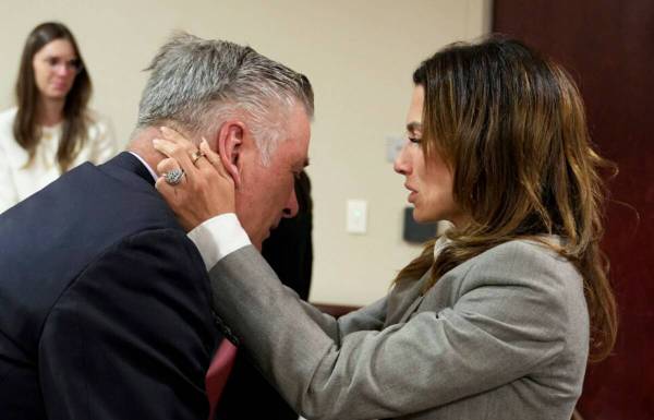 Actor Alec Baldwin, left, and his wife Hilaria embrace after a judge threw out the involuntary ...