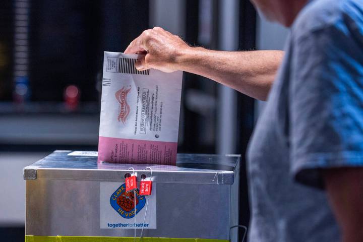 A voter drops off his mail ballot during Nevada's primary election day at the polls within the ...