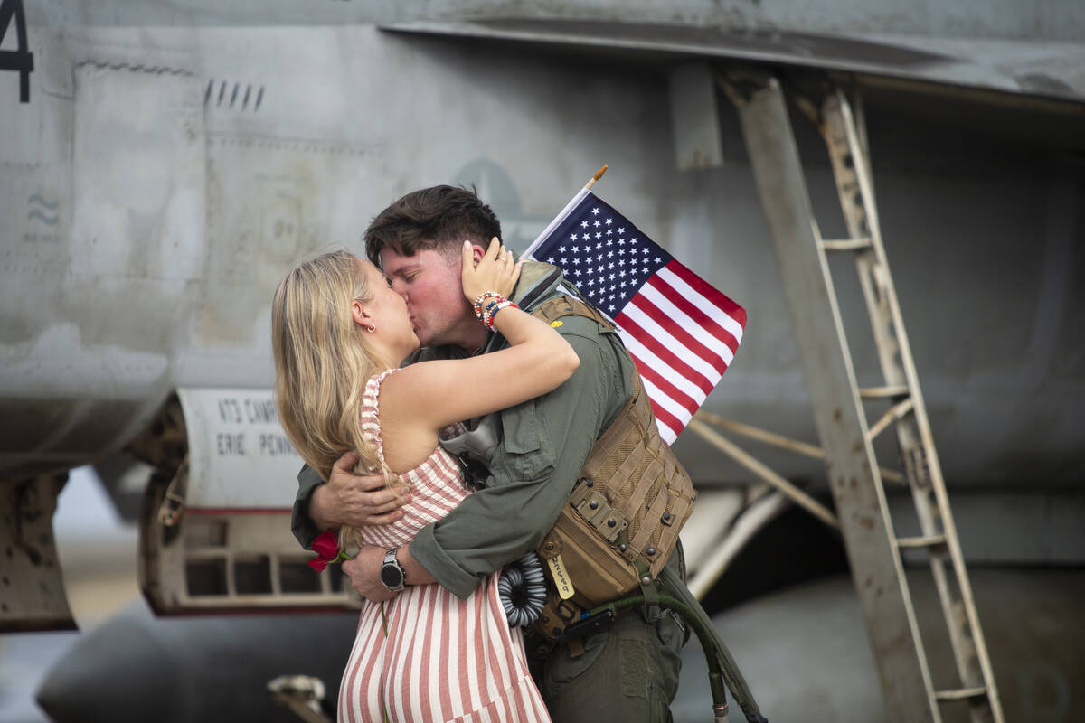 Lindsay Nelson kisses her husband, Robert "Fat Goose" Nelson, after he returned to NA ...