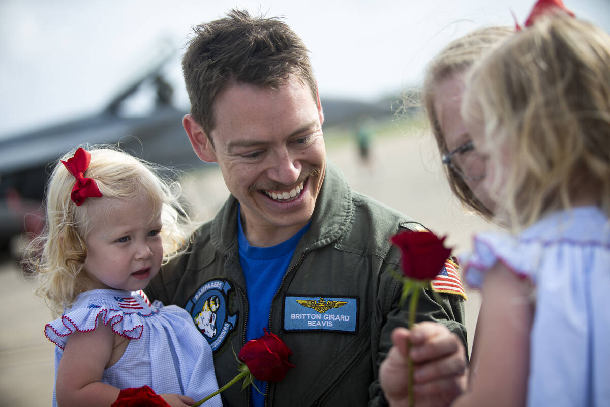 Britton "Beavis" Girard of Strike Fighter Squadron 83 presents a rose to his daughter ...