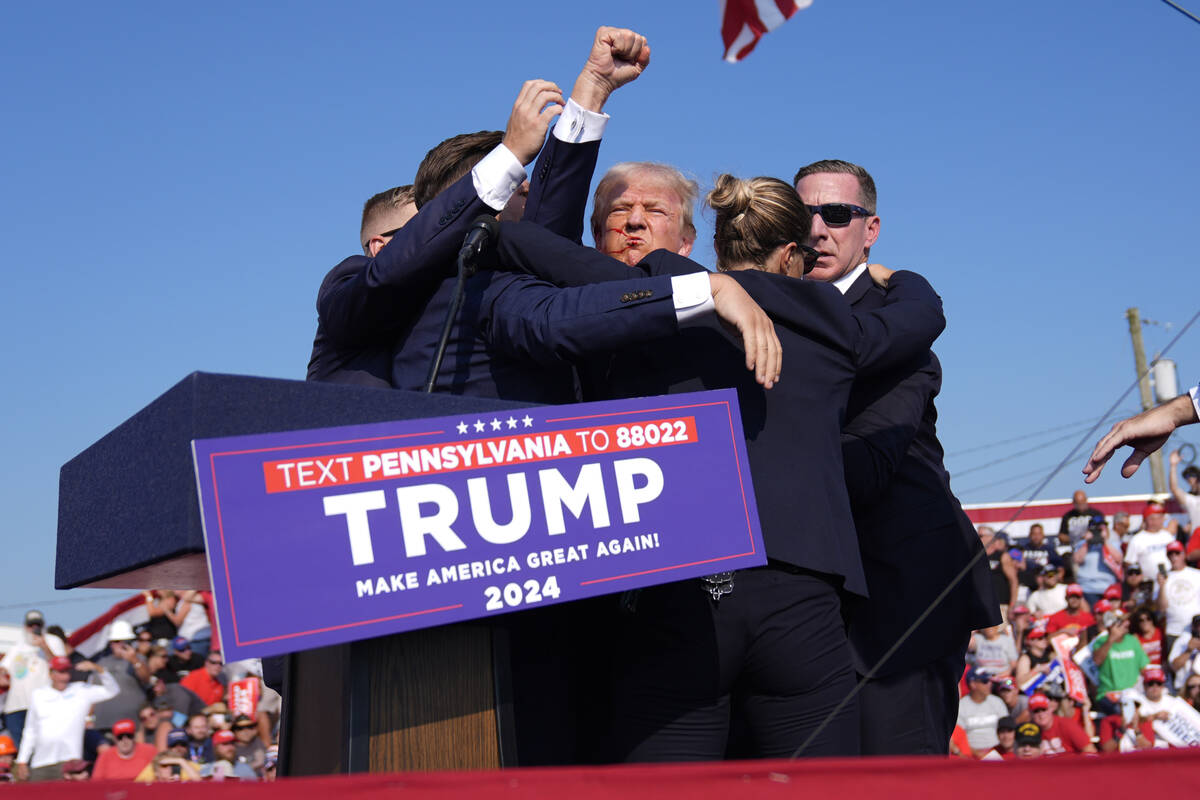 Republican presidential candidate former President Donald Trump is surrounded by U.S. Secret Se ...