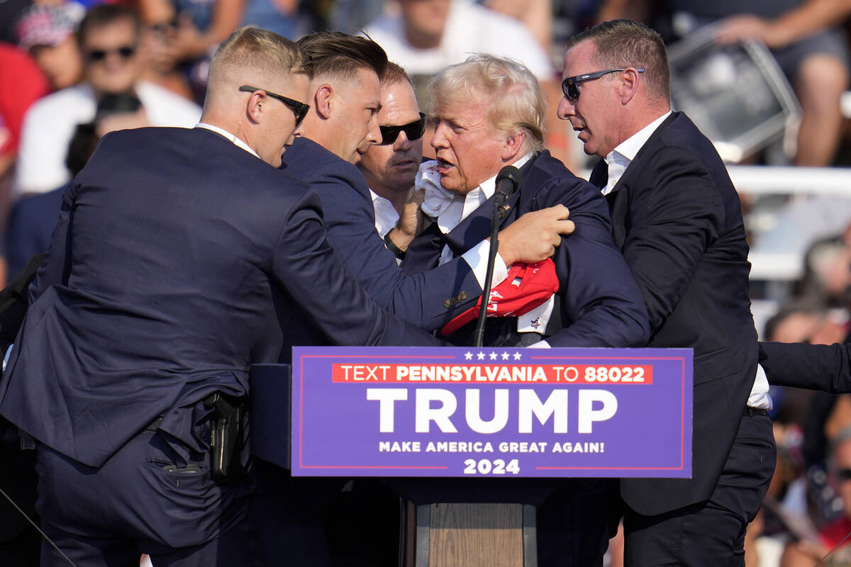 Republican presidential candidate former President Donald Trump is helped off the stage at a ca ...