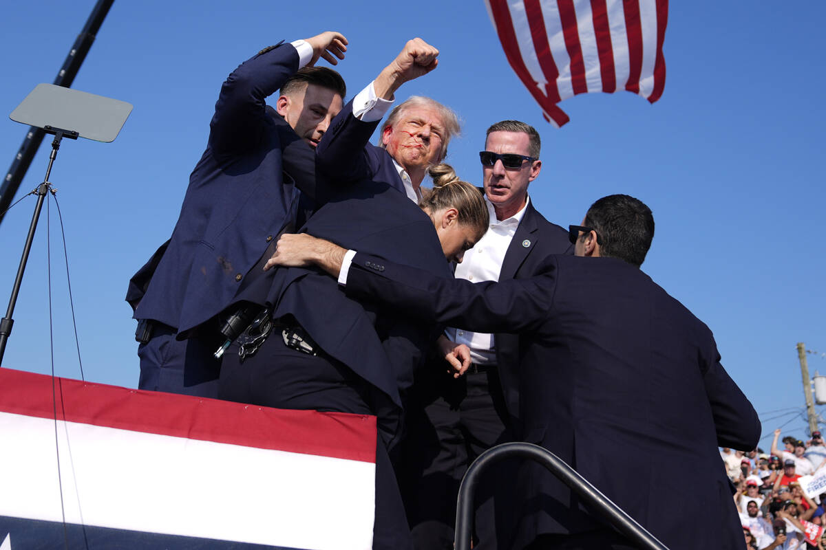 Republican presidential candidate former President Donald Trump is surrounded by U.S. Secret Se ...