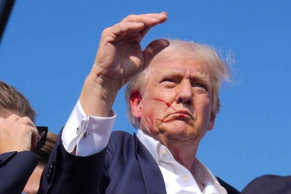Republican presidential candidate former President Donald Trump waves from the stage as he is s ...
