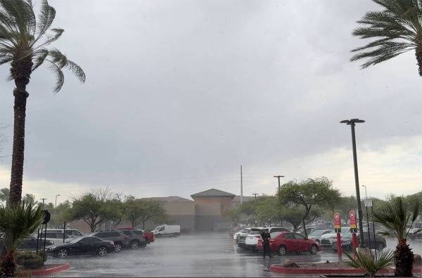 A sudden downpour hits the parking lot at Albertson's at West Charleston Boulevard and Town Cen ...