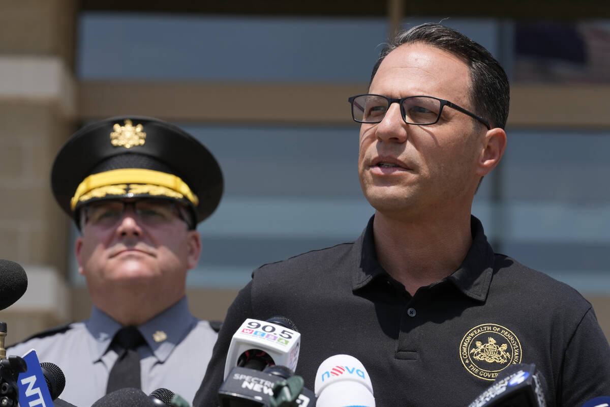 Josh Shapiro, right, governor of Pennsylvania, speaks during a news conference, in Butler, Pa., ...