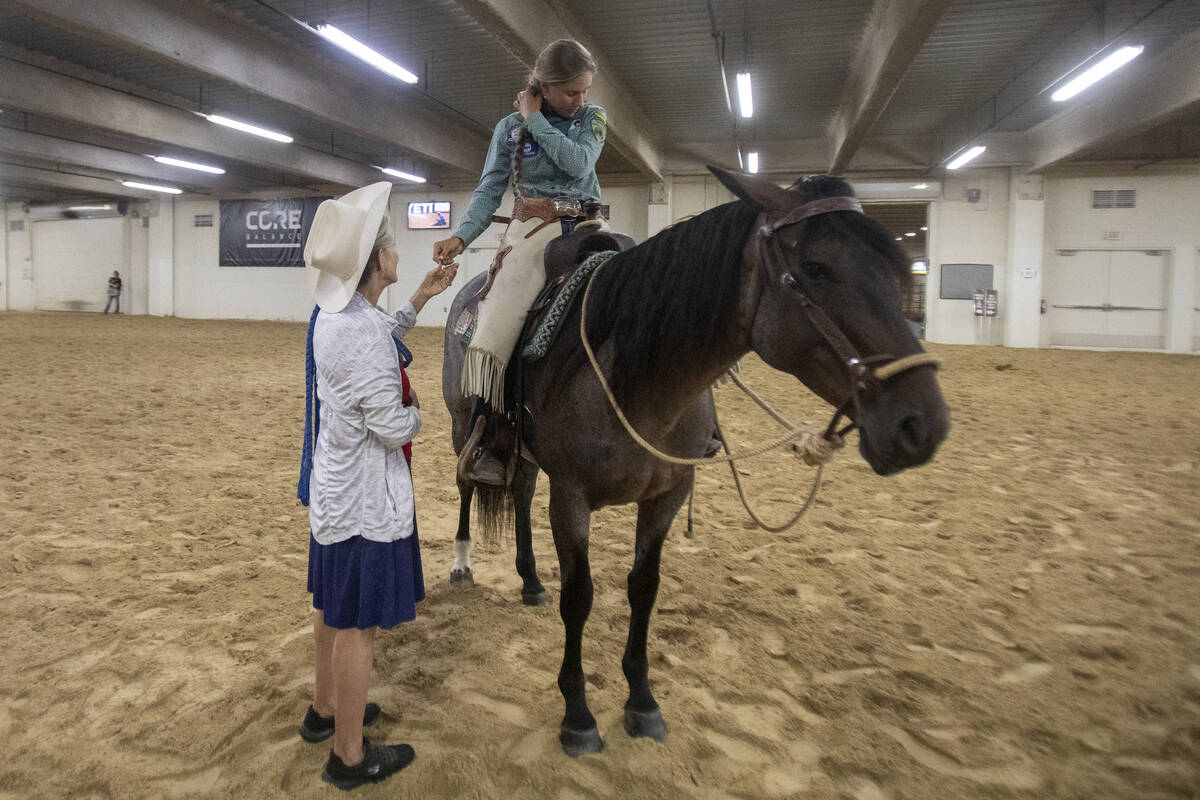 Joni Huber, left, of Floresville, Texas, helps her daughter Kaylianna, right, with her hair bef ...