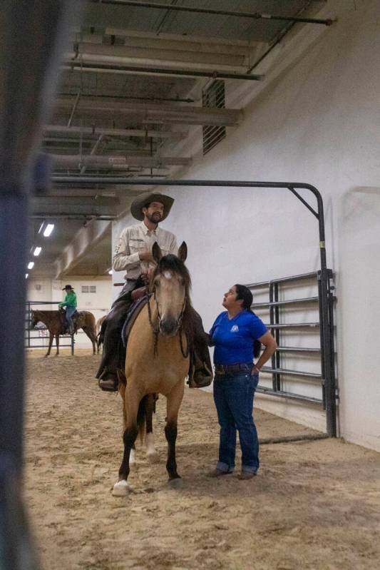 Competitors wait in a chute before competing in the Mustang Challenge at South Point Arena, Fri ...