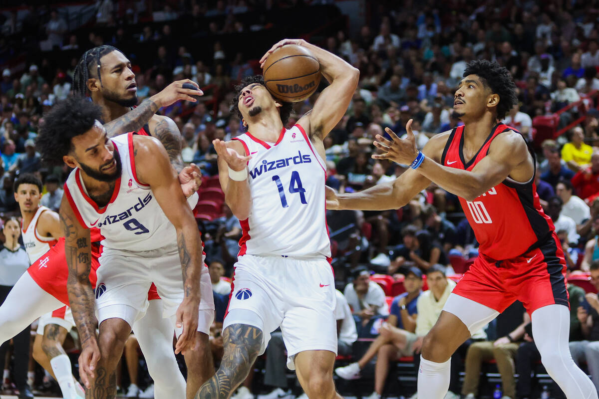 Washington Wizards guard Jules Butler (14) reaches up for the ball as it comes down from a fail ...