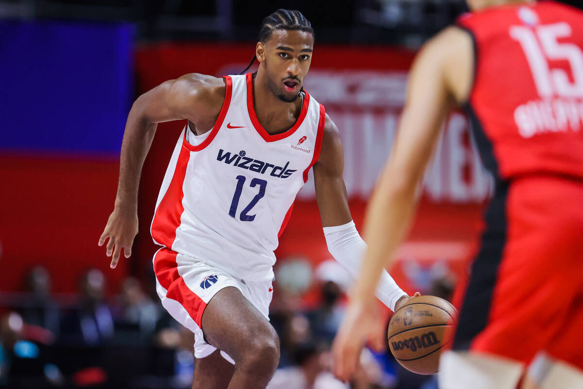 Washington Wizards center Alex Sarr (12) dribbles the ball during an NBA Summer League game bet ...