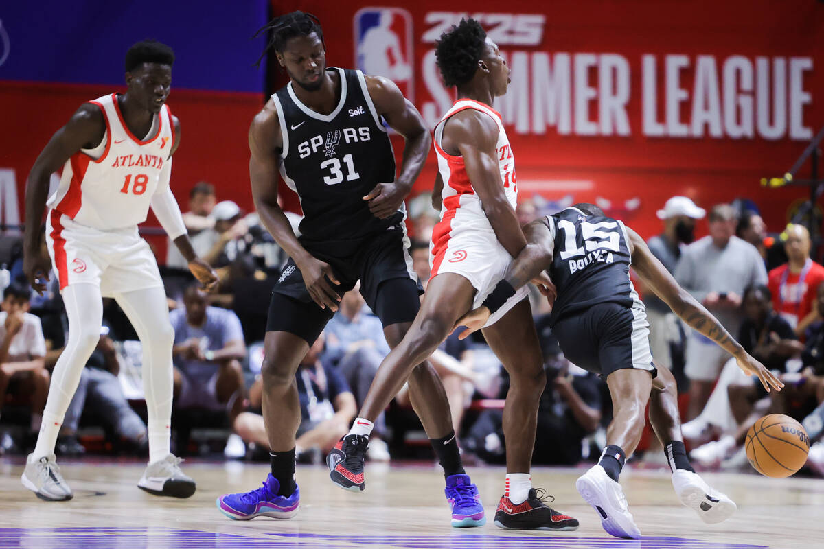 San Antonio Spurs guard Jamaree Bouyea (15) drives the ball past Atlanta Hawks guard Jarkel Joi ...