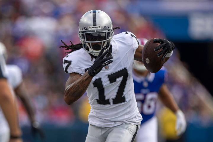 Raiders wide receiver Davante Adams (17) runs after making a catch during the first half of an ...