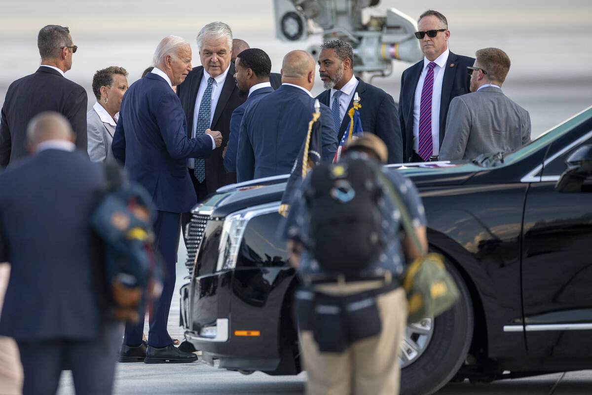 President Joe Biden talks to, from left, former Governor Steve Sisolak, Clark County Commission ...