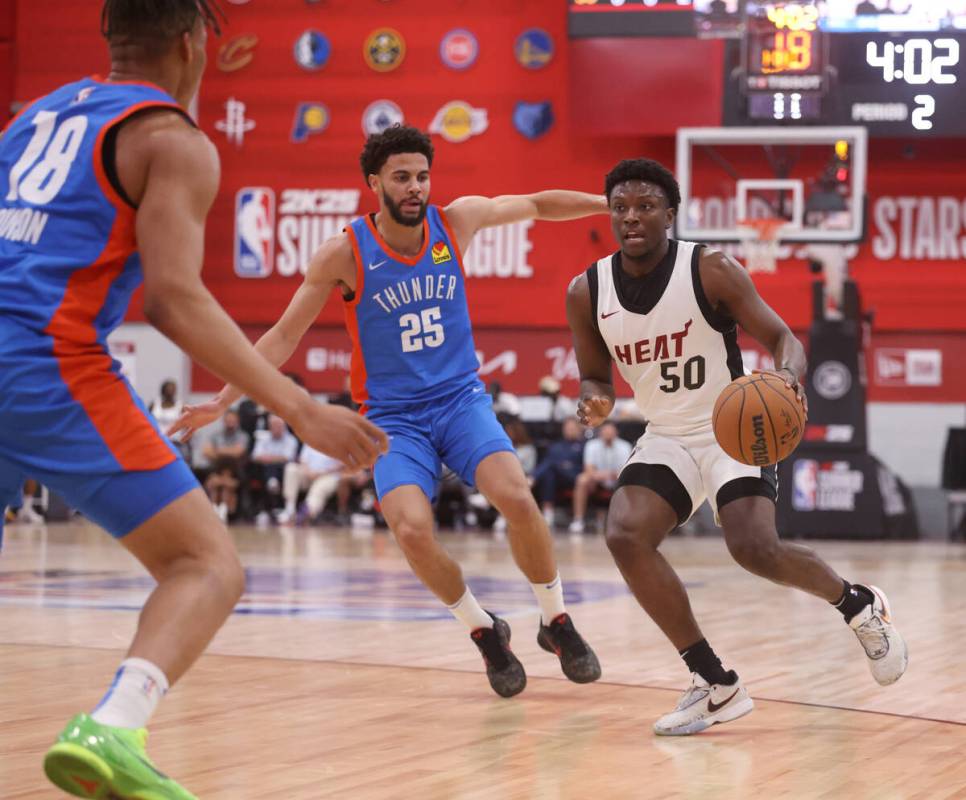 Miami Heat guard Isaiah Stevens (50) drives against Oklahoma City guard Ajay Mitchell during an ...