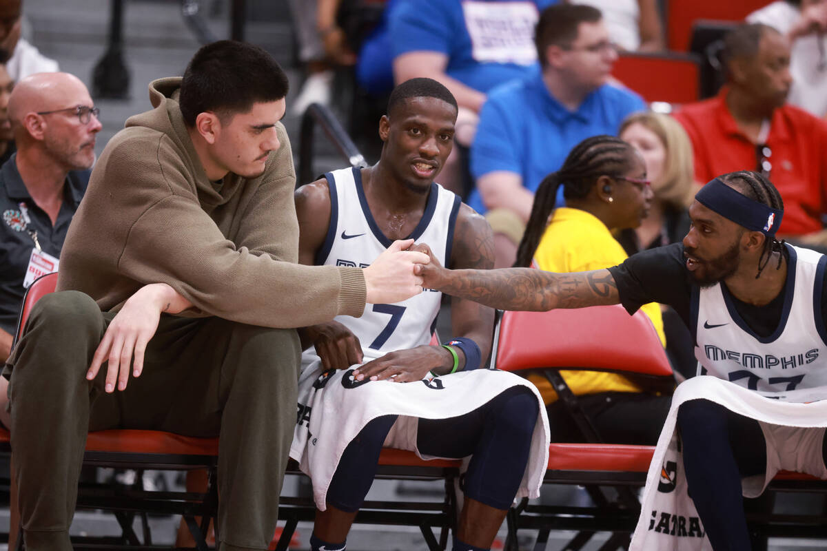 Memphis center Zach Edey, left, watches his team take on the Dallas Mavericks during an NBA Sum ...