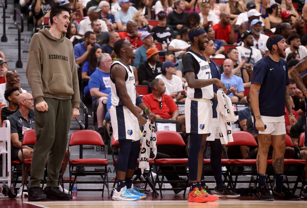 Memphis center Zach Edey, left, watches his team take on the Dallas Mavericks during an NBA Sum ...