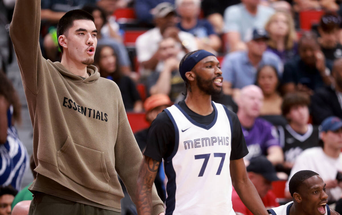 Memphis center Zach Edey, left, watches his team take on the Dallas Mavericks during an NBA Sum ...