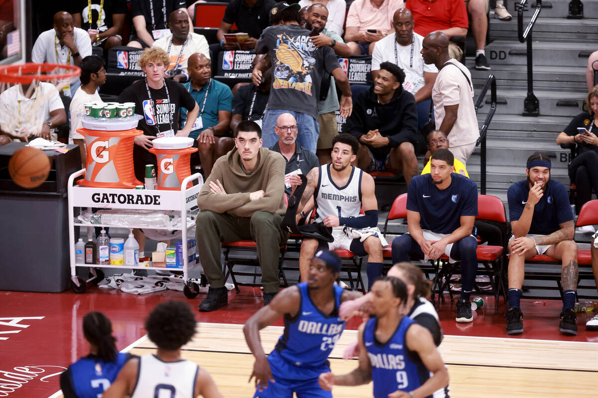 Memphis center Zach Edey, left, watches his team take on the Dallas Mavericks during an NBA Sum ...