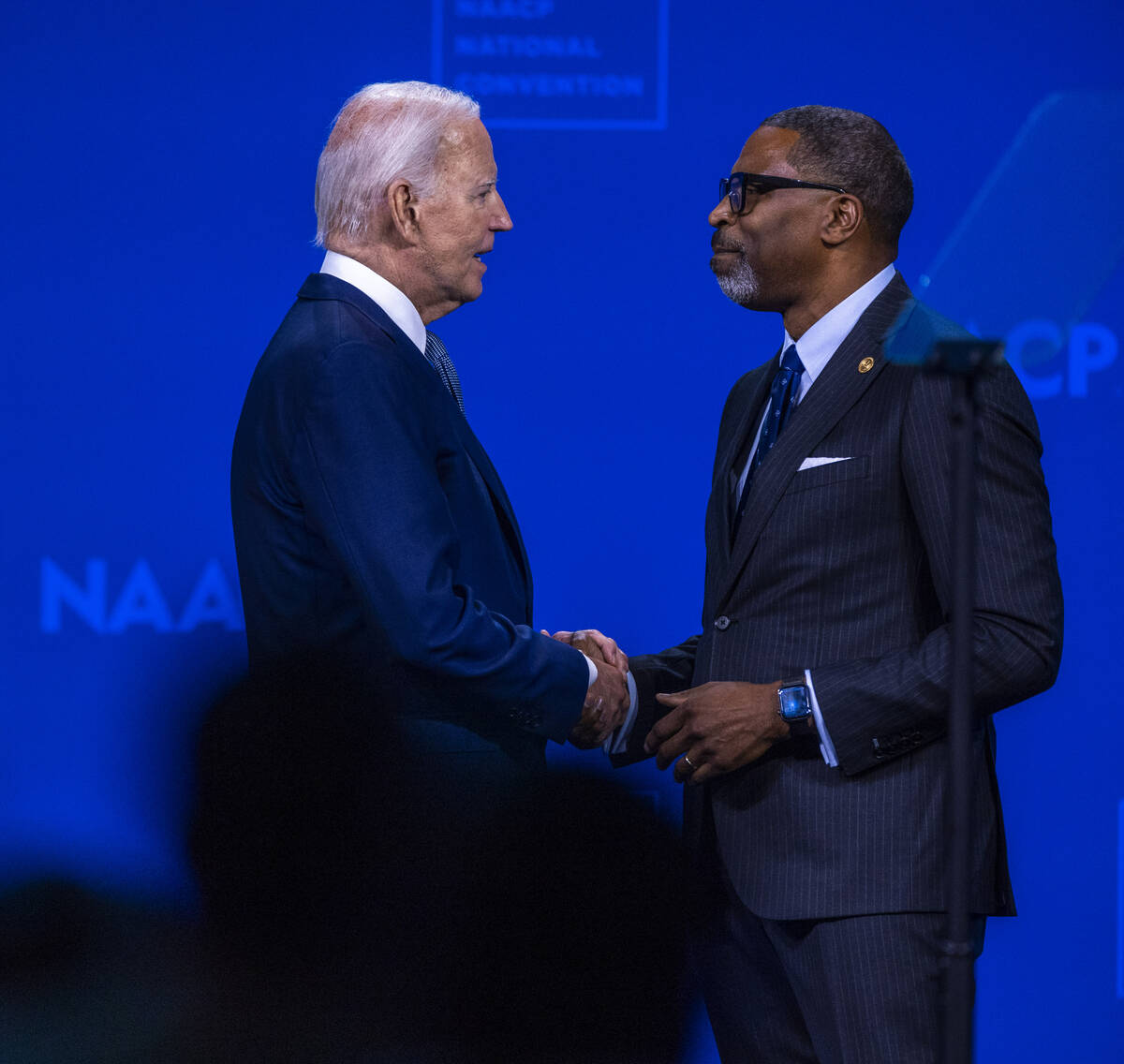 President Joe Biden greets NAACP President and CEO Derrick Johnson as he takes the stage to spe ...