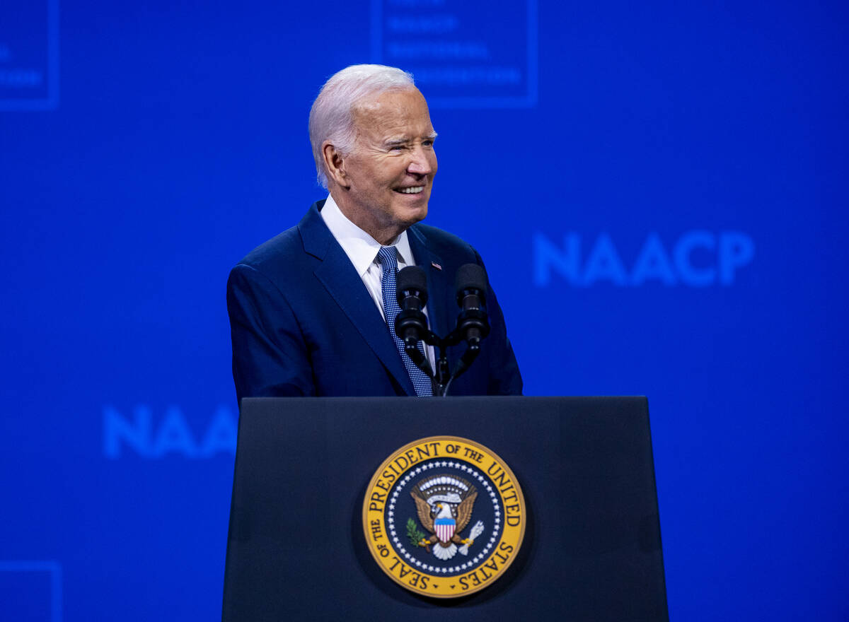 President Joe Biden smiles at the crowd while speaking during the 115th NAACP National Conventi ...