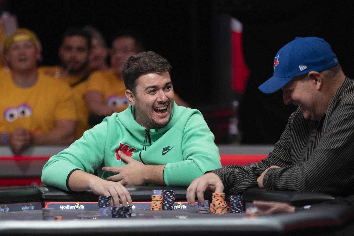 Andres Gonzalez, left, and Jason Sagle, right, laugh while competing in the final table of the ...