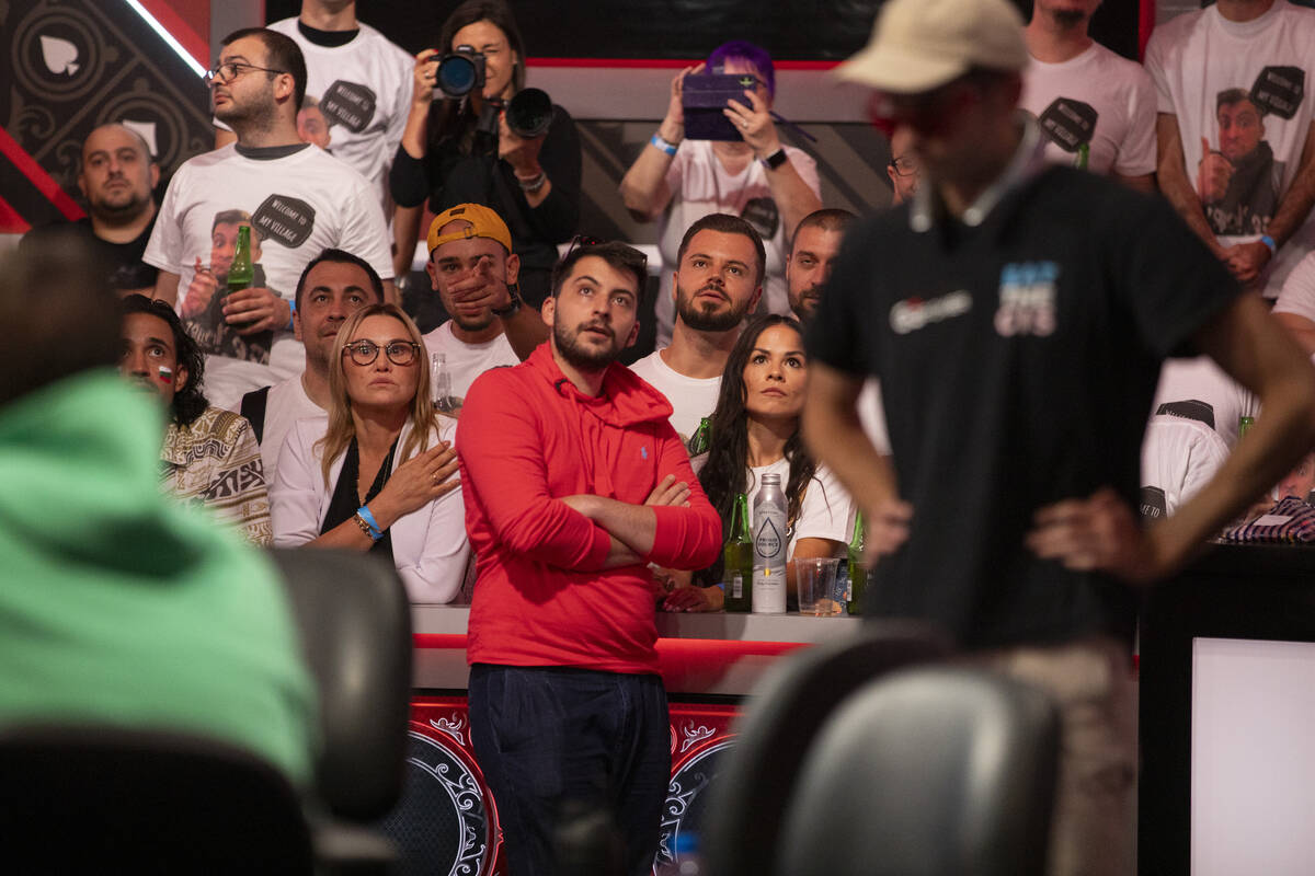 Boris Angelov watches a pair of hands play out with family and friends during the final table o ...