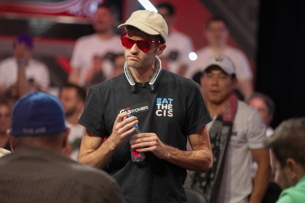 Joe Serock looks at his losing hand that knocked him out of competition during the final table ...