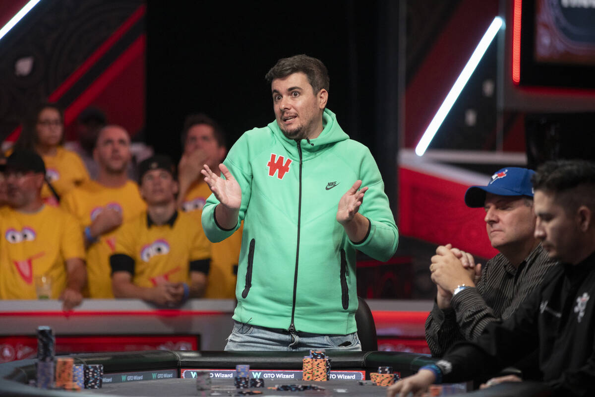 Andres Gonzalez talks to family and friends in the crowd while competing in the final table of ...