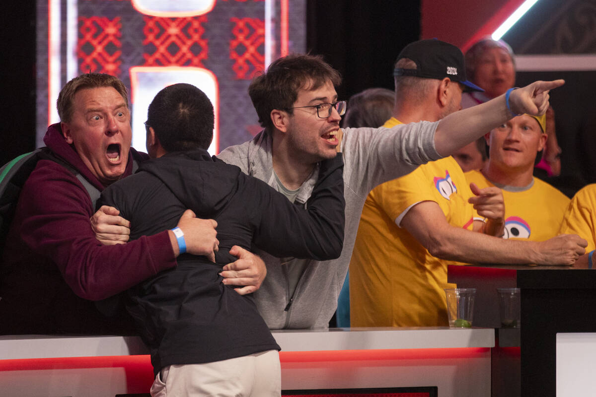 Jonathan Tamayo, center, celebrates with family and friends while competing in the final table ...