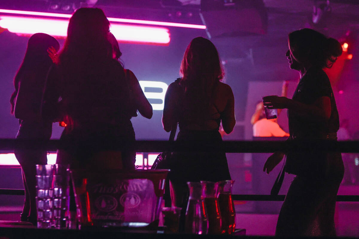 Club goers are seen during a soft opening event at Substance, a new nightclub at Neonopolis on ...