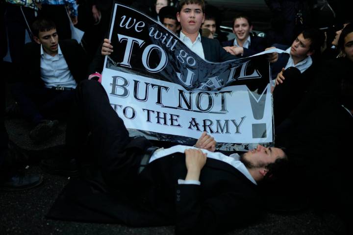 Ultra-Orthodox Jewish youth block a road to protest military recruitment in Bnei Brak, near Tel ...