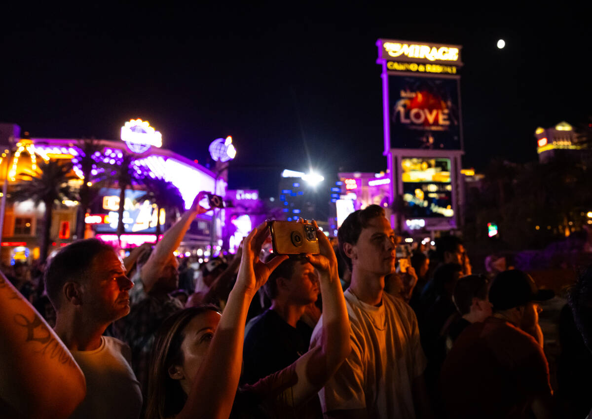 People watch the final scheduled volcano show during the final night of operations and gaming a ...