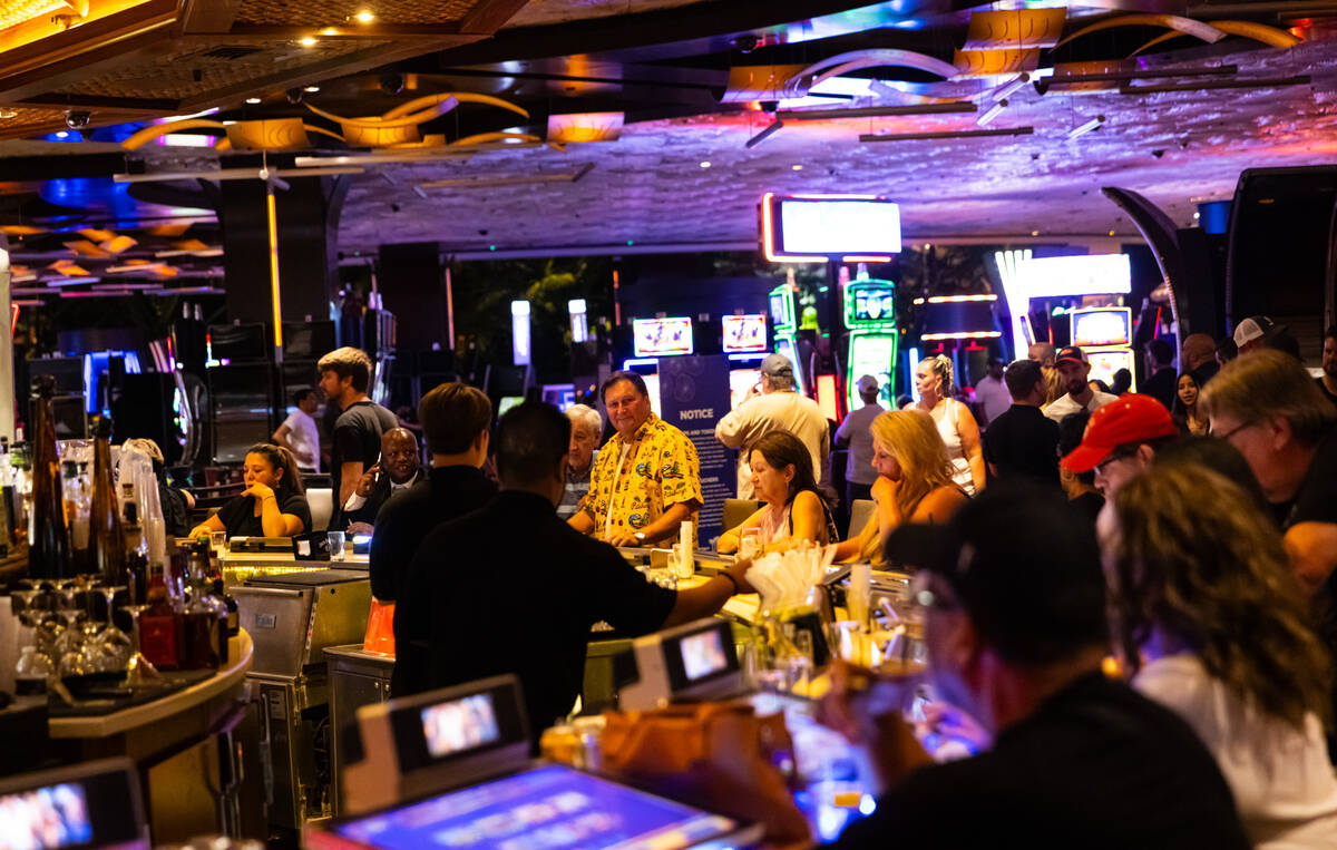 People drink at a bar during the final night of operations and gaming at The Mirage on Tuesday, ...