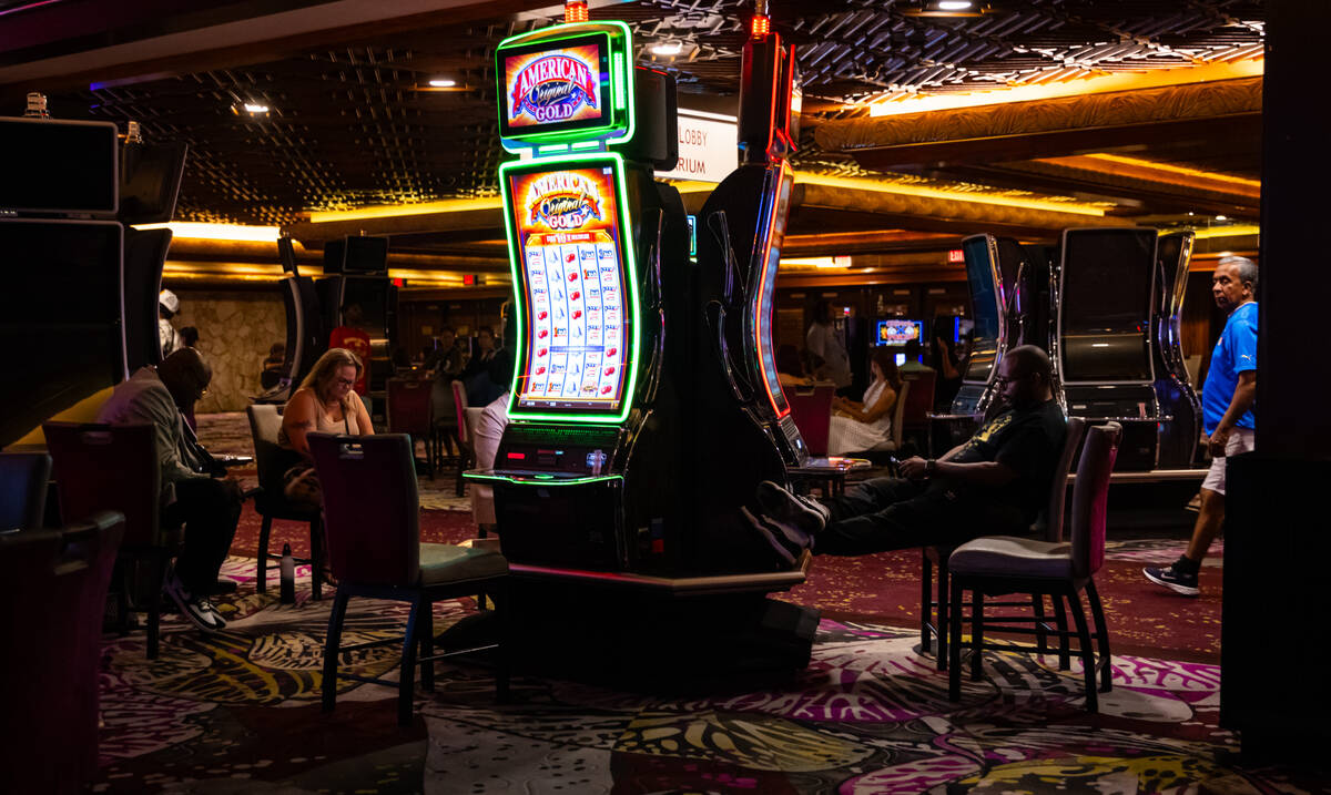 People play slot machines during the final night of operations and gaming at The Mirage on Tues ...