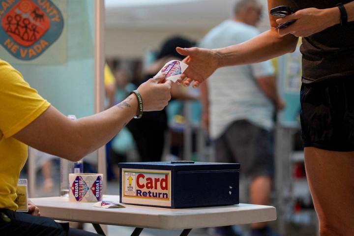 A voter receives an “I Voted” sticker after casting their ballot during the Nevada Primary ...