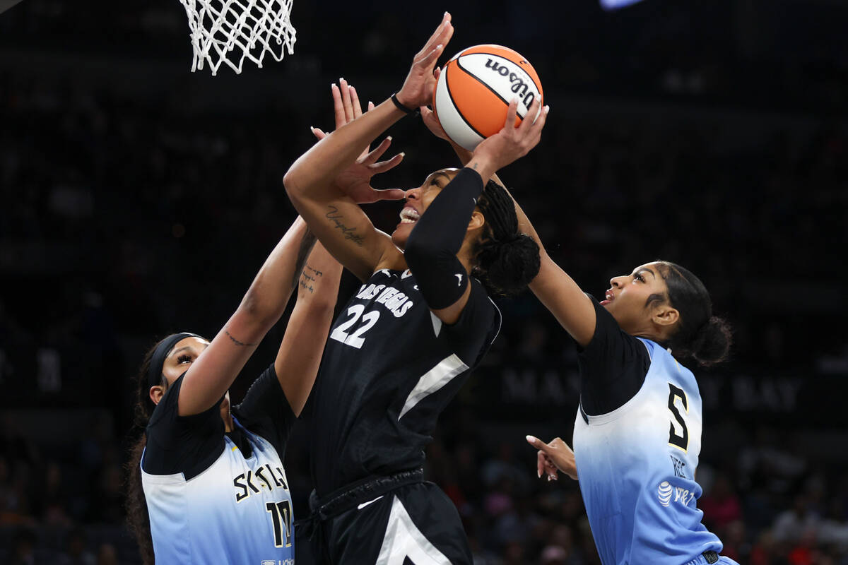 Las Vegas Aces center A'ja Wilson (22) shoots while Chicago Sky center Kamilla Cardoso (10) and ...