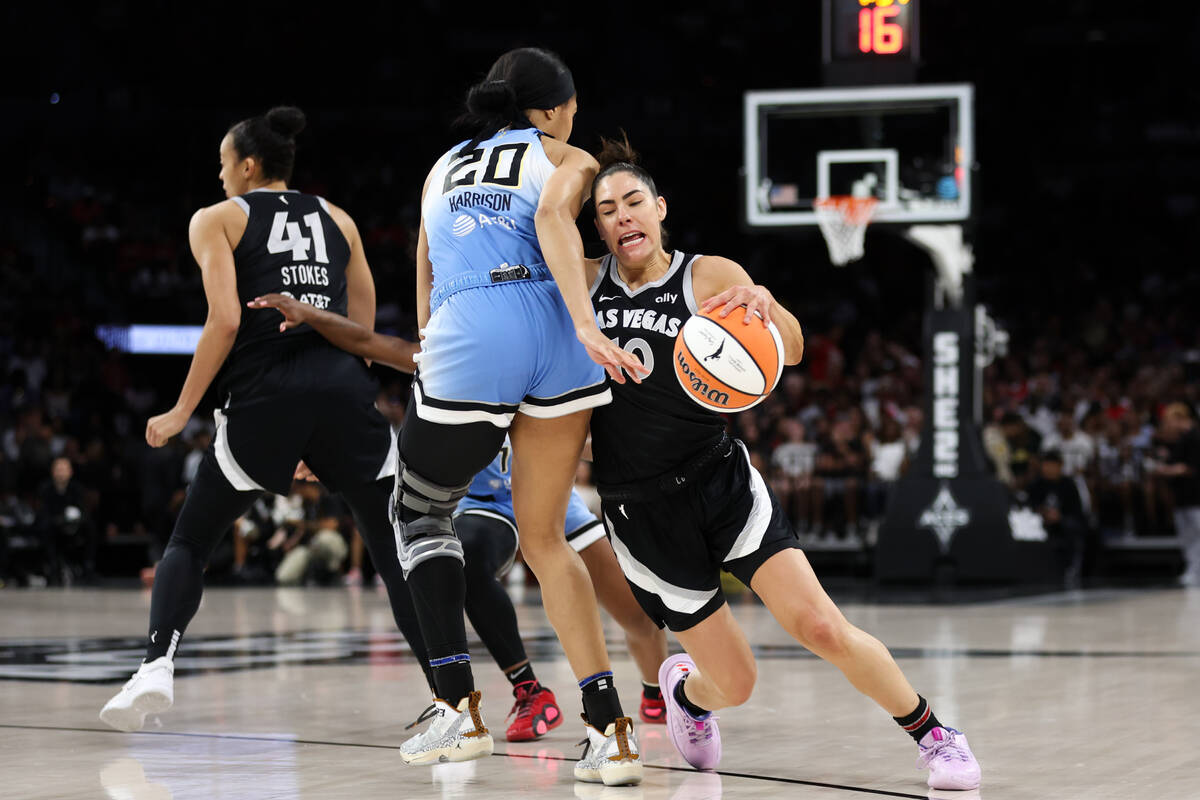 Las Vegas Aces guard Kelsey Plum (10) drives around Chicago Sky forward Isabelle Harrison (20) ...